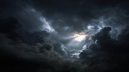Obraz premium Ominous storm clouds fill the sky, creating a dramatic atmosphere with rays of sunlight breaking through. The scene suggests an impending storm on the horizon.