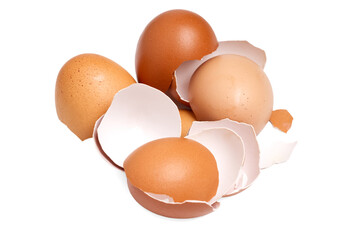 brown egg shell broken or crack with pieces scattered on the surface.