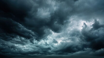 Obraz premium Dark, swirling clouds loom ominously over the horizon as the sun sets, casting a moody atmosphere over the landscape. Wind picks up, signaling an approaching storm.