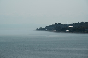 Misty Water Surface With a Stirring Landscape In The Background