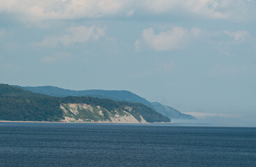 Coastal Cliffscape With Fog Rolling Over The Ocean Horizon