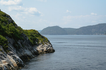 Stunning coastal view with cliffs and serene waters on a bright sunny day.