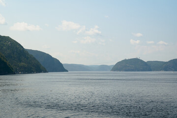 Majestic hills and serene waterway creating a tranquil scenic landscape.