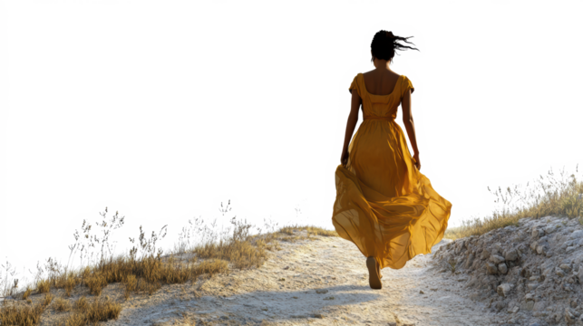 Woman in yellow dress walking in sunlight
