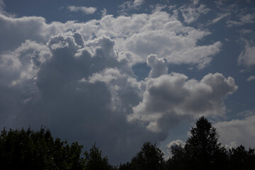 White clouds in the sky. The atmosphere in summer. Air mass.