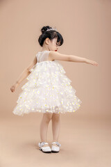 A little Asian girl in a white dress