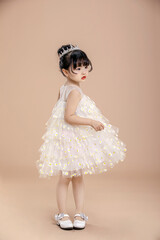 A little Asian girl in a white dress