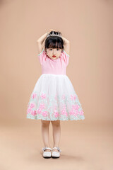 An Asian little girl in a pink dress