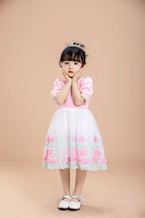An Asian little girl in a pink dress