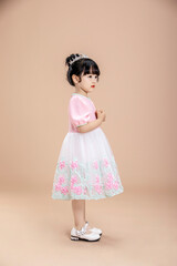 An Asian little girl in a pink dress