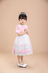 An Asian little girl in a pink dress