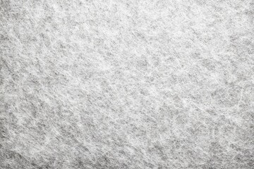 Close-up view of a textured, light gray fabric or material.  Fine fibers create a slightly uneven surface