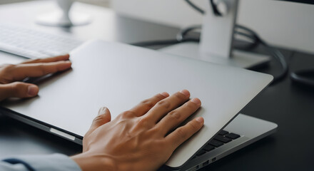 Close up of hands closing a silver laptop computer modern technology device digital workspace office work productivity efficiency innovation technology progress future