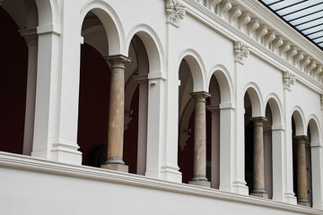 Interior view of classic building with white arches and columns. Concept of culture, architecture...