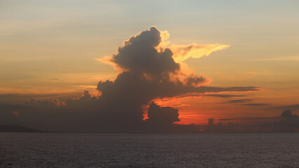 Sunrise clouds above contours of Jamaica shores