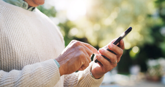 Senior man, hands and phone outdoor for typing message, retirement research or reading online news. Elderly person, smartphone and scrolling in nature for social media update and download mobile app