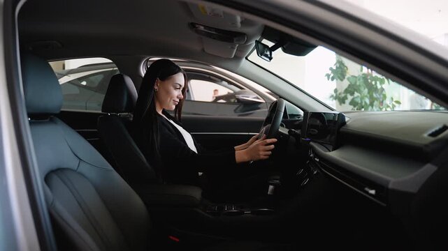 Saleswoman testing dashboard navigation system in new car