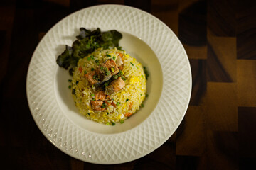 Plate Of Salmon Fried Rice On Rustic Wooden Table