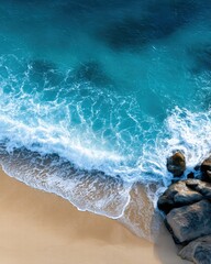 Beautiful coastal seascape featuring vibrant blue ocean waves crashing against rocky shoreline with sandy beach and scenic horizon perfect for travel and nature lovers