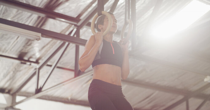 Athlete, woman and gymnastic rings for fitness with exercise, stability training and core workout. Female person, equipment and club for sports practice, strong muscles and body balance for challenge