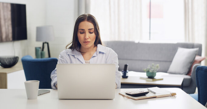 Calculator, laptop and remote work with woman in living room of home for notes, planning or research. Computer, finance and small business with freelance employee at desk in apartment for agenda