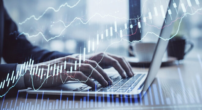 Person typing on laptop with stock market charts overlay trading finance