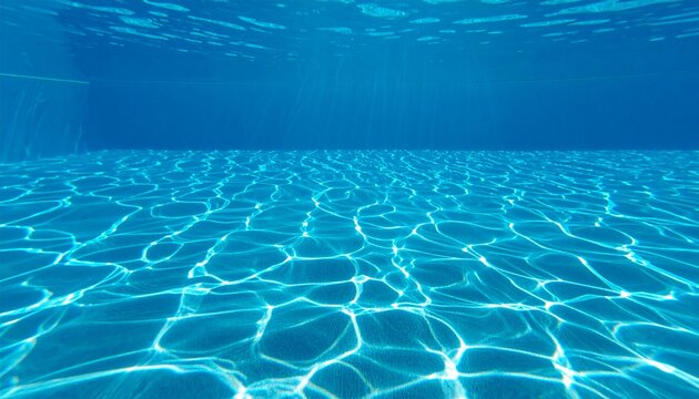 Underwater view of a swimming pool with sunbeams and caustic light patterns shimmering