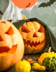Two carved pumpkins in Halloween d?cor