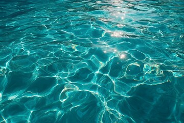 Fototapeta premium Clear blue water with sunlight reflections.
