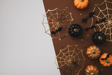 Halloween background with party decorations from pumpkins, bats, spiderweb top view. Mystic autumn greeting card.
