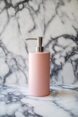 A minimalist pink soap dispenser sits elegantly on a marble surface.
