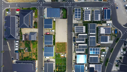 Directly above aerial drone view of a residential area in a modern city with solar panels