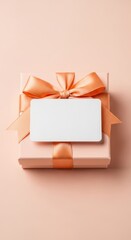 Peach gift box with orange ribbon and blank card for message