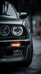Fototapeta premium Close-up view of a dark gray car's front end