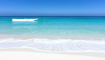 Fototapeta premium A beautiful beach scene with turquoise water and white sand under a clear blue summer sky horizon