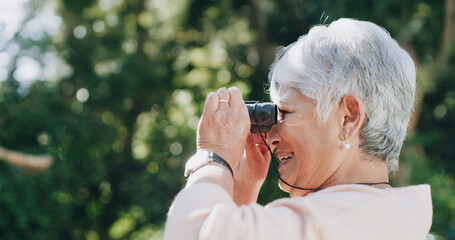 Smile, senior woman and binocular outdoor for travel, bird watching and holiday sightseeing. Happy, elderly person and nature observation with equipment, wildlife study and view of vacation discovery © peopleimages.com