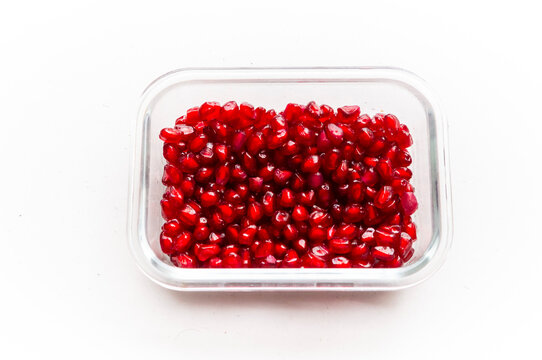 Pealed pomegranate seeds in a glass rectangular bowl