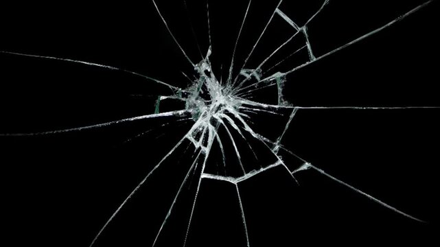 Glass Shattered and Breaks with Bullet Hit, cracks glass fracture effect texture isolated abstract black background.
Abstract cracked screen effect with intricate jagged fractures 