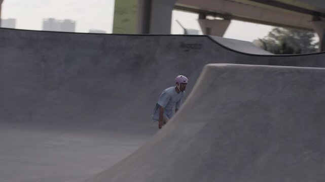 Aggressive inline skater rides ramp showing skill in skatepark