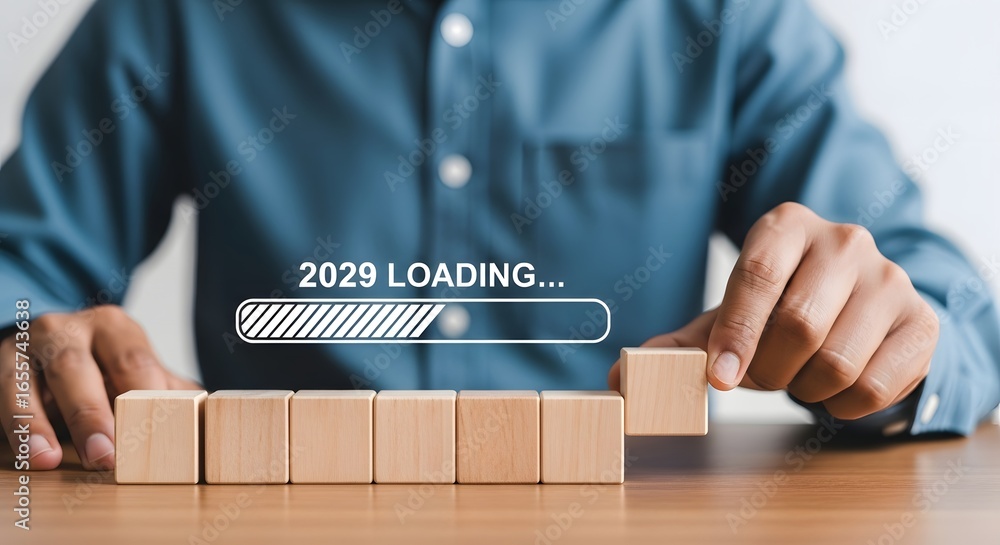 Aufkleber person placing wooden block with loading bar graphic indicating the year twenty twenty nine