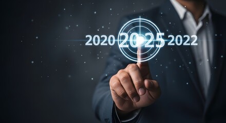 A man in a suit pointing to a target with the year numbers projected on a dark background scene