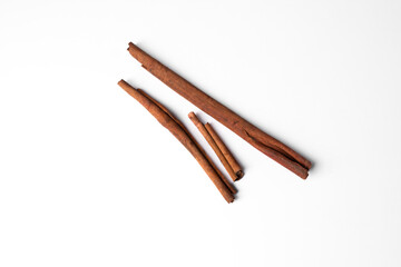 Cinnamon sticks isolated on white background, aromatic spice ingredient for cooking, baking, tea, and natural herbal health remedies.