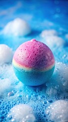 Obraz premium Colorful bath bomb dissolving in blue water with gentle foam and bubbles