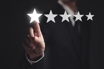 Businessman pointing five star symbol to increase rating of company