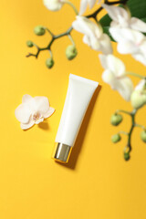top view cosmetic sunscreen and flower