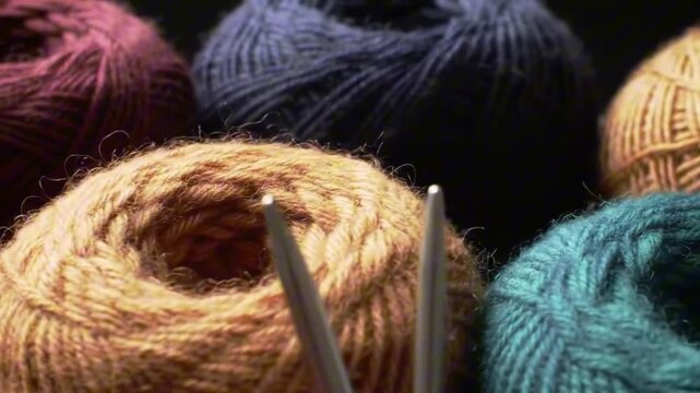 Colorful yarn balls with knitting needles in a closeup creating a crafting scene