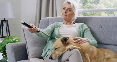 Mature woman, dog and watching tv on couch, relax and subscription for movies in living room....