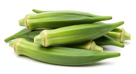 Obraz premium Fresh green okra pods piled together on a white background