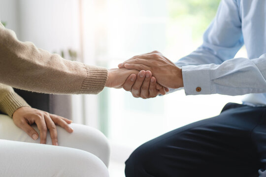 Counselor touching friend shoulder and encouraging to help relieve her sad