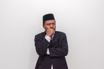 Pensive Indonesian Man in Suit and Songkok Lost in Deep Contemplation
